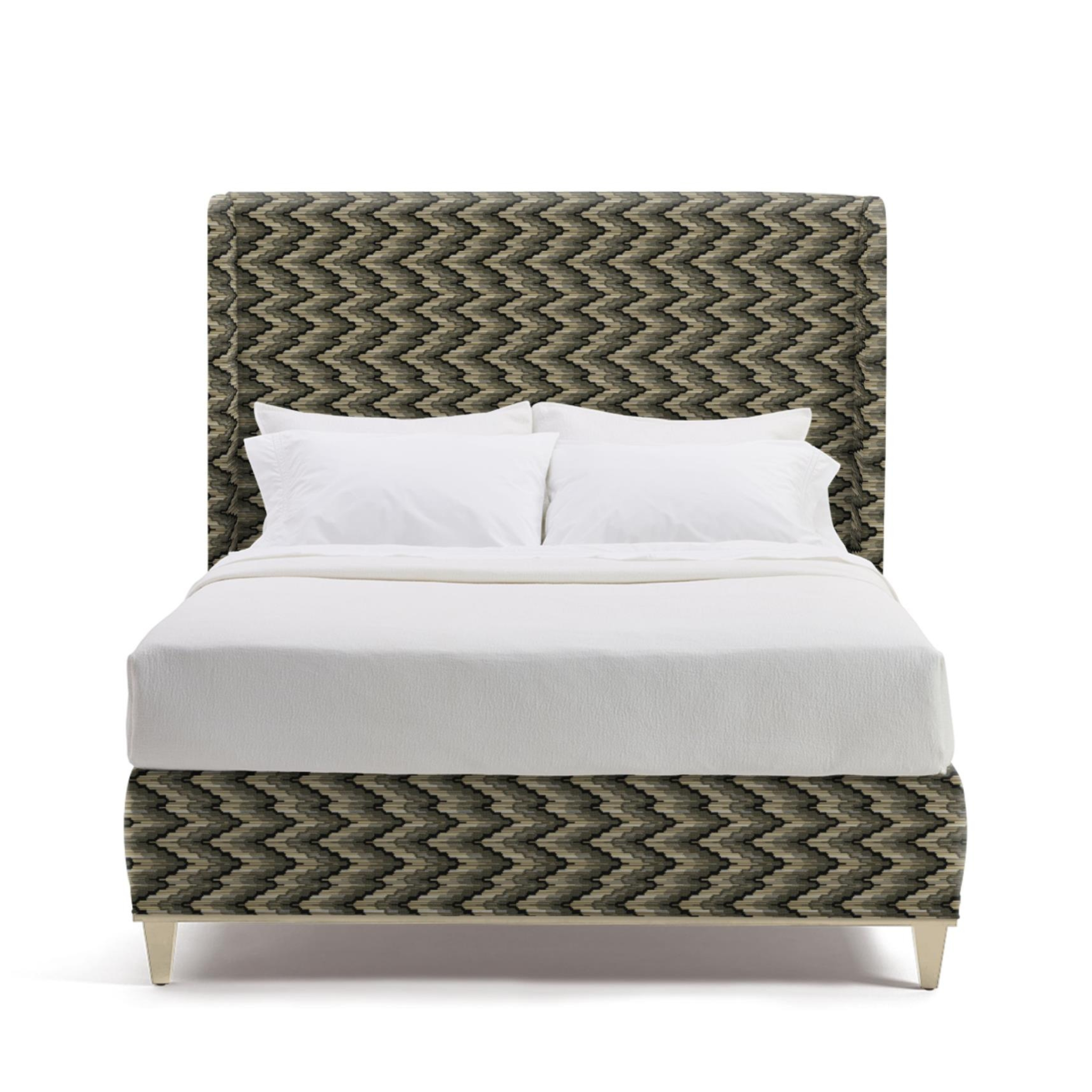 Bed with chevron patterned headboard and footboard on a white background
