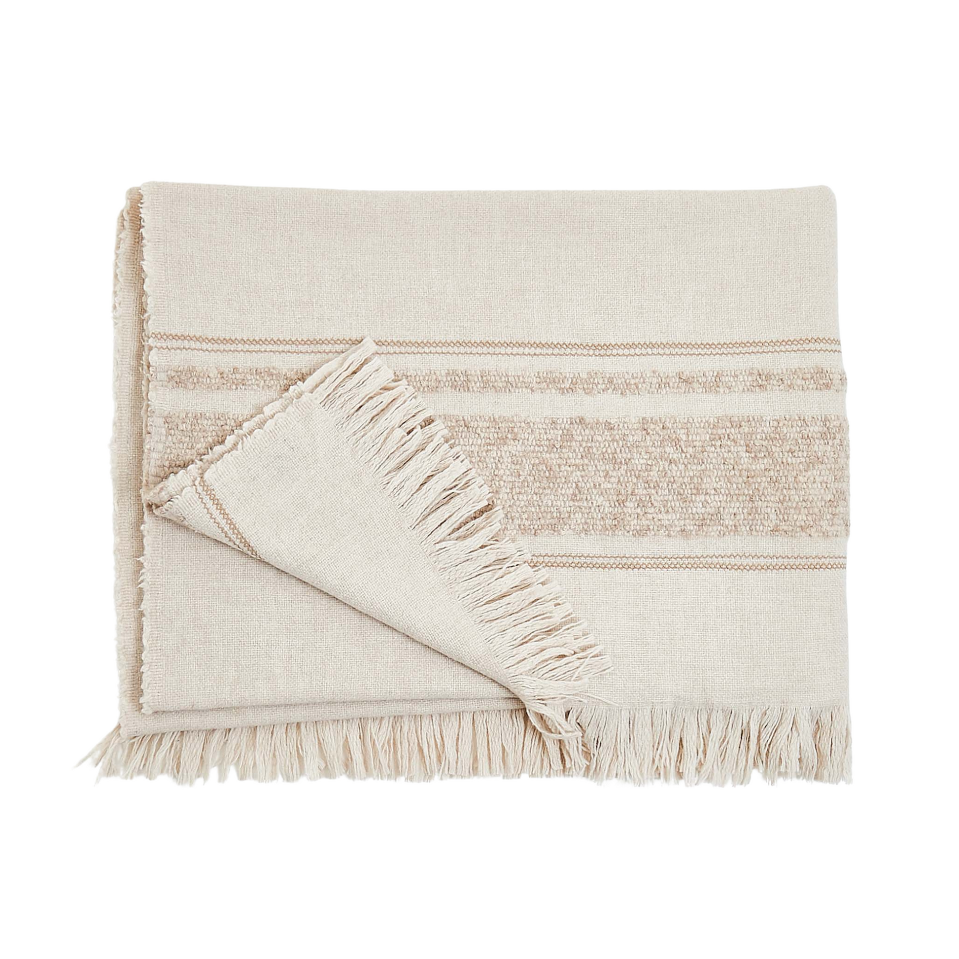 Little Nell Throw in Tan by Fineza – soft woven decorative blanket on white background.
