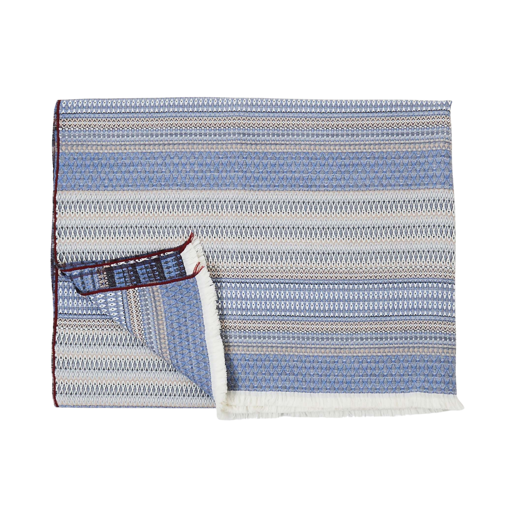 “St. Regis Throw in Bluestone by Fineza – soft woven decorative blanket on white background.”